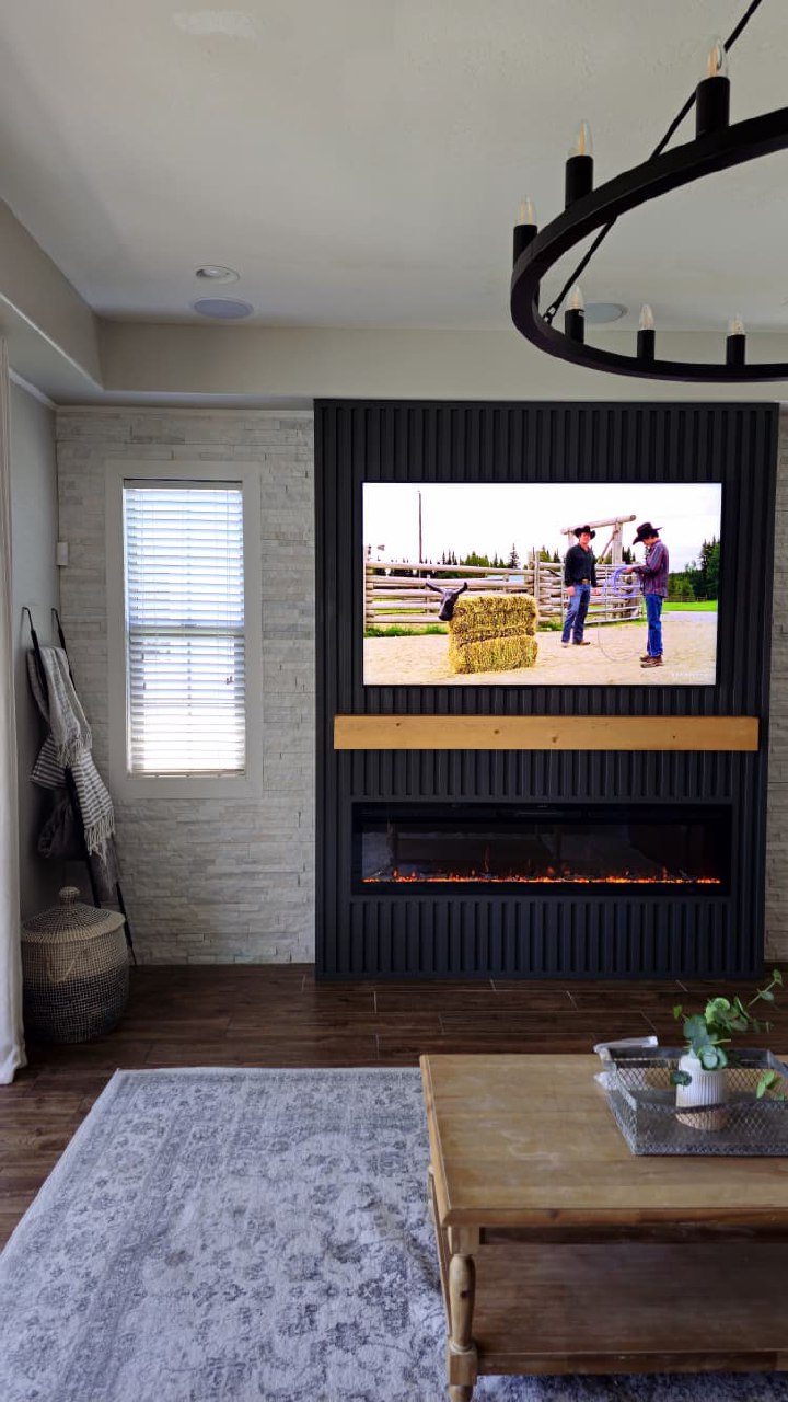 Black chevron TV wall full room view with dark shelves windmill fan Arizona