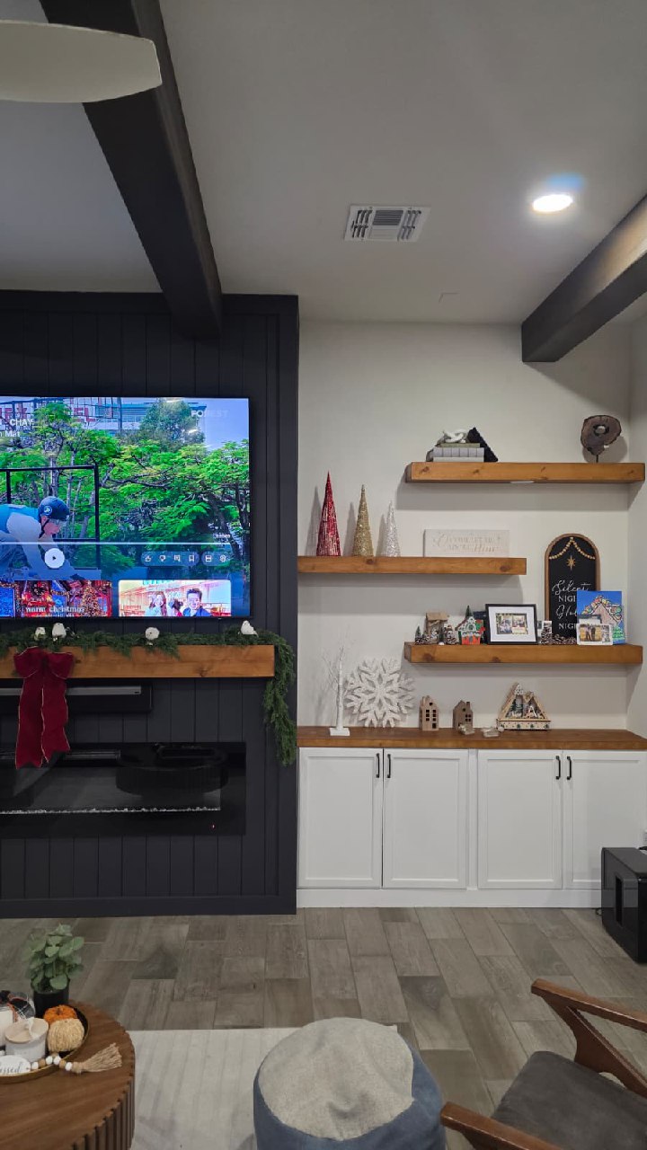 Dark shiplap accent wall with TV mount and floating shelves Arizona