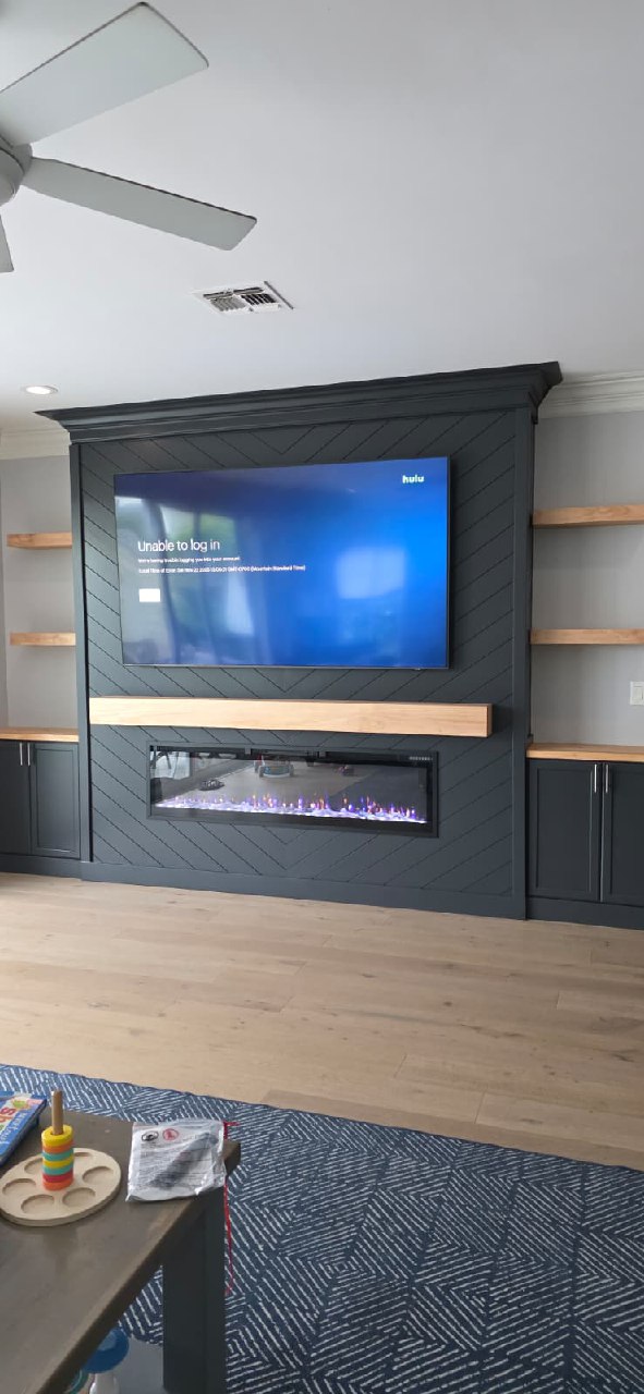 Dark charcoal diagonal shiplap accent wall with fireplace and floating shelves Arizona
