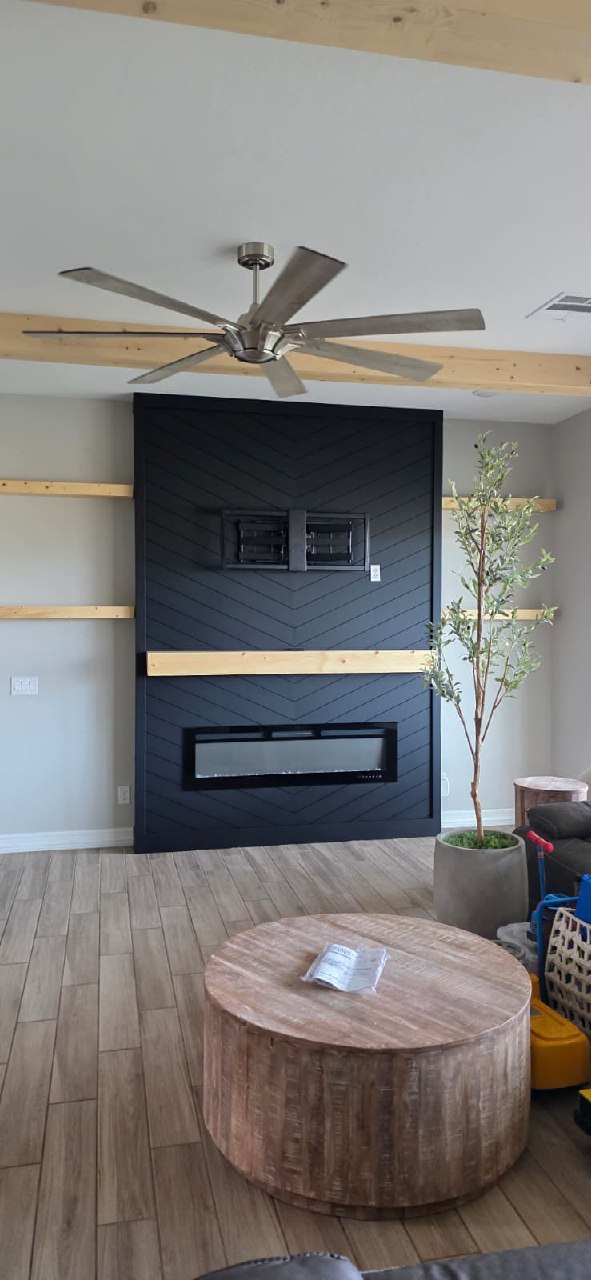 Dark grey fluted molding accent wall with brass sconce lights and dining chairs Arizona