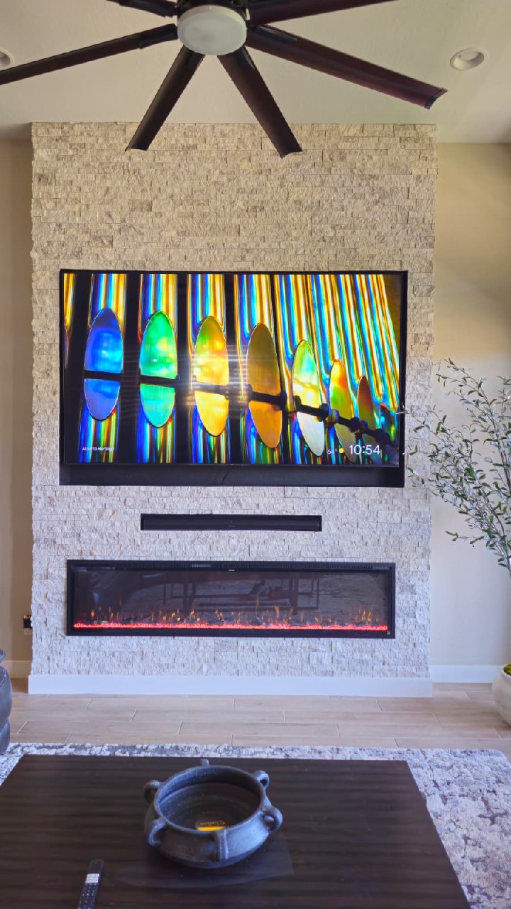 Dark grey fluted panel accent wall close-up with twin brass sconce lighting Arizona
