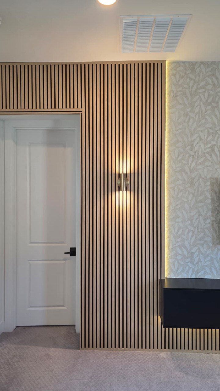 Dark shiplap entertainment wall with floating shelves white cabinets and purple fireplace Arizona