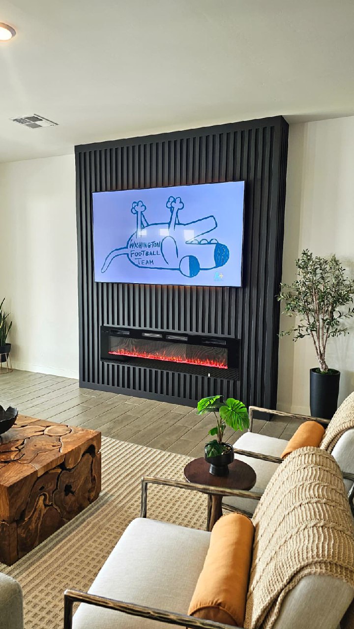 Dark slat TV wall with oak wood mantle fireplace full room leather sofa Arizona