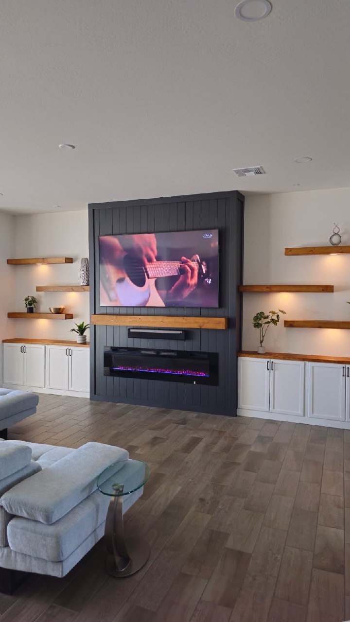Dark slat TV wall with stone surround fireplace insert Arizona