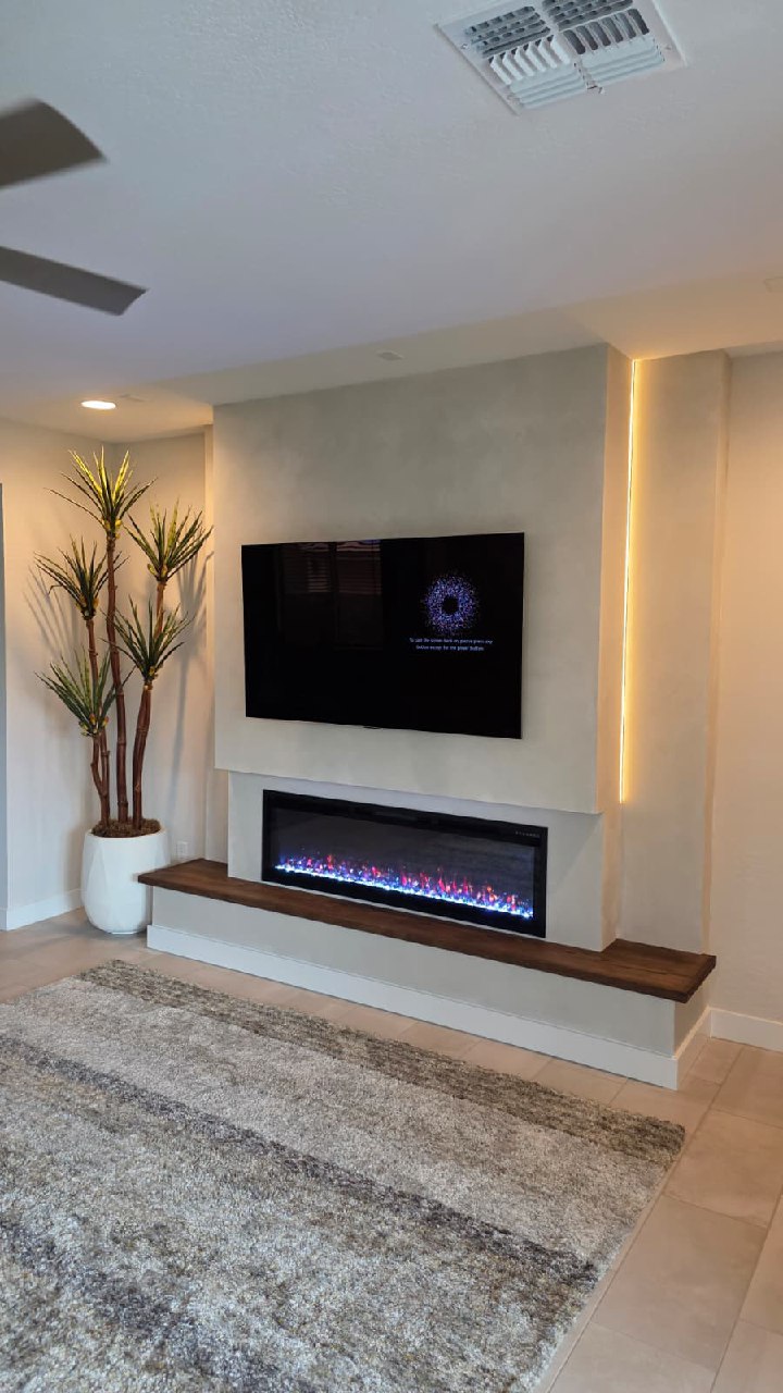Dark vertical shiplap TV wall with wood mantle linear fireplace and hardwood floors Arizona