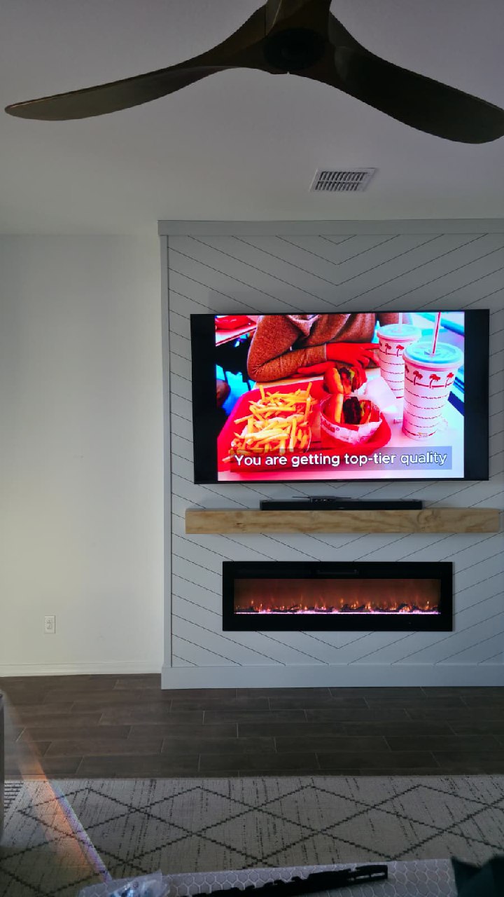 Dark vertical slat TV wall panel with full width white lower cabinets Arizona