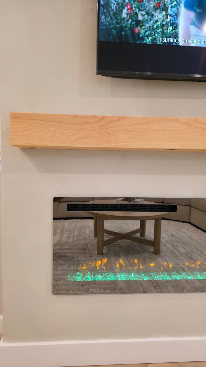 Linear electric fireplace close-up with green crystals and orange flame Arizona