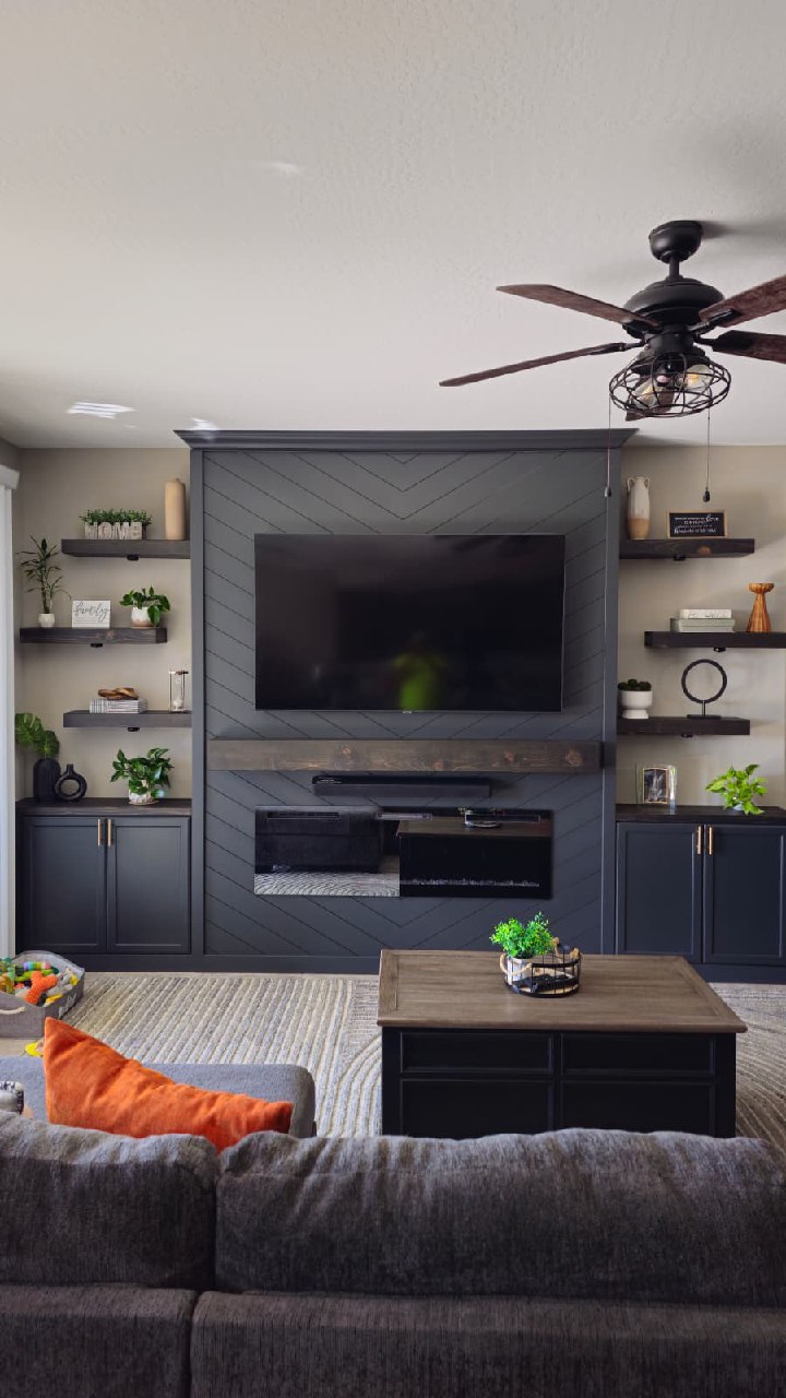 Modern concrete TV wall with vertical LED strips fireplace and tropical plants Arizona