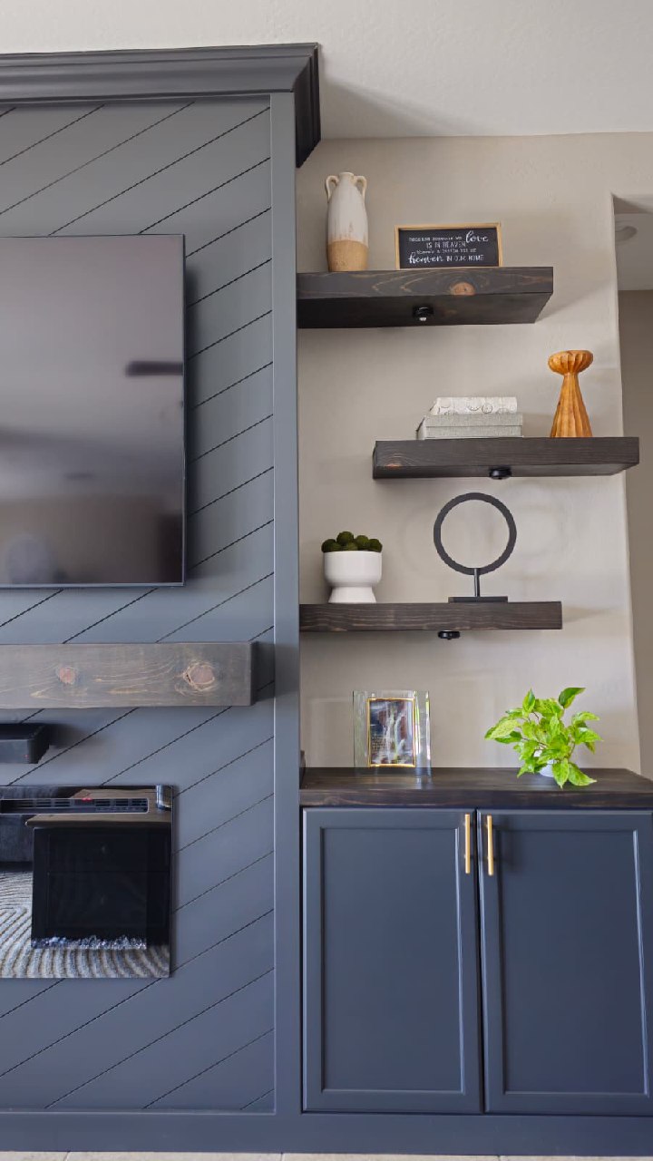 Steel grey chevron TV wall detail with navy lower cabinet and dark floating shelves Arizona