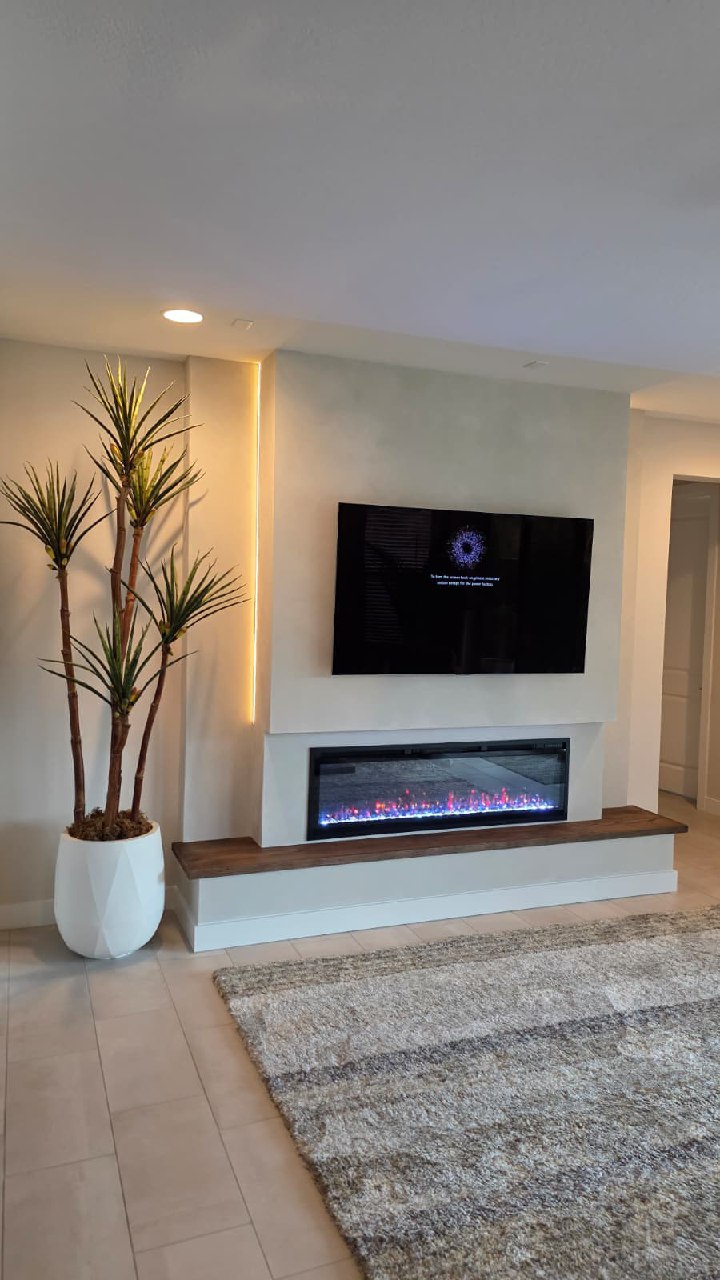 White chevron shiplap TV wall with fireplace angled view Arizona