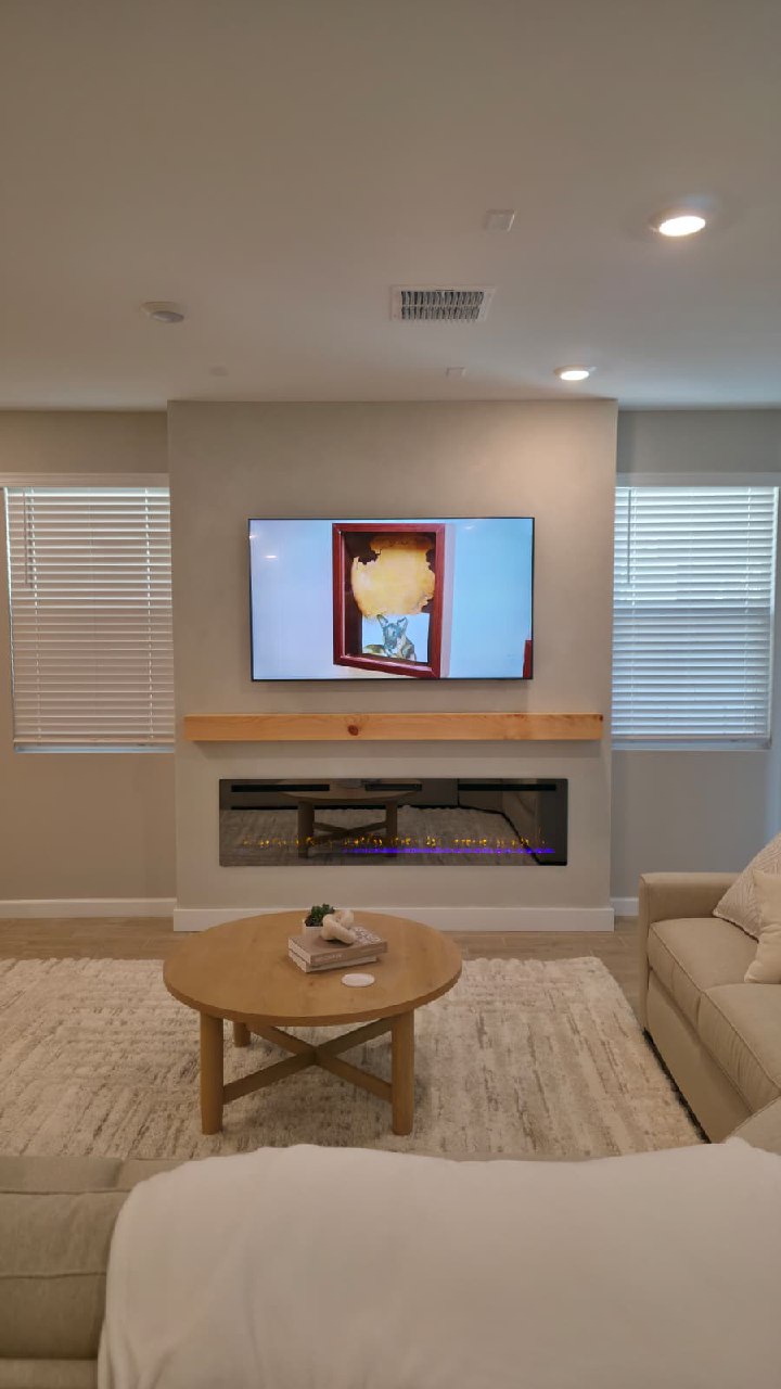 White minimal TV wall with chandelier and dual flame electric fireplace Arizona
