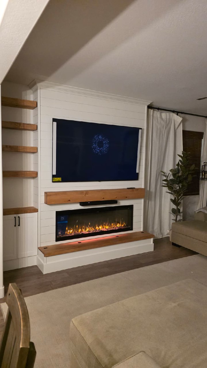 White shiplap entertainment wall with fireplace and wood floating shelves Arizona