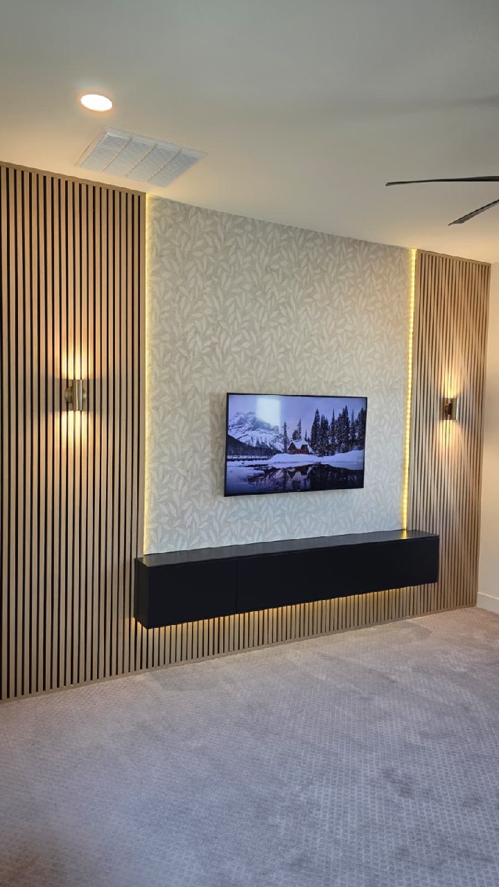 Symmetric wood slat accent wall with wallpaper TV center and warm ambient lighting Arizona