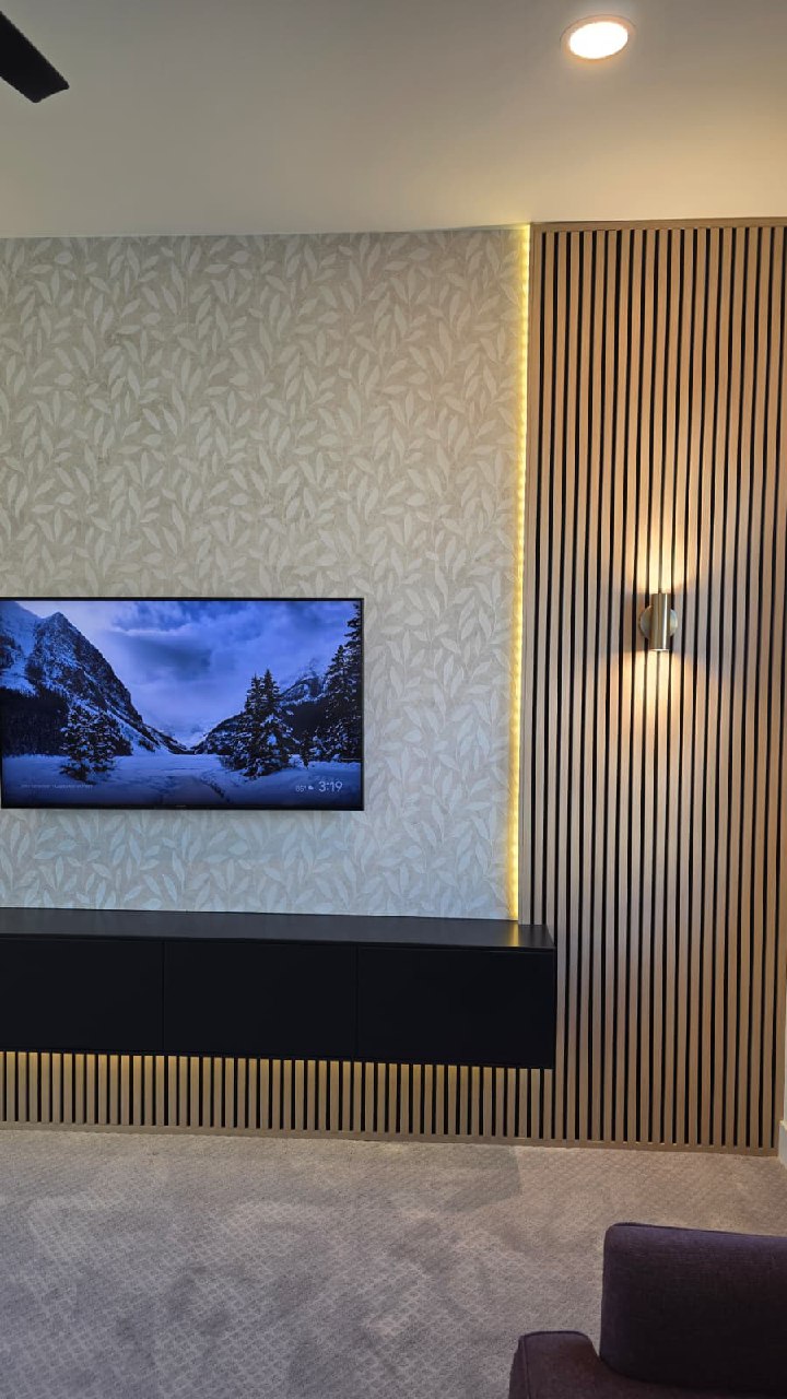 Wood slat wall with TV and warm LED lighting side detail Arizona