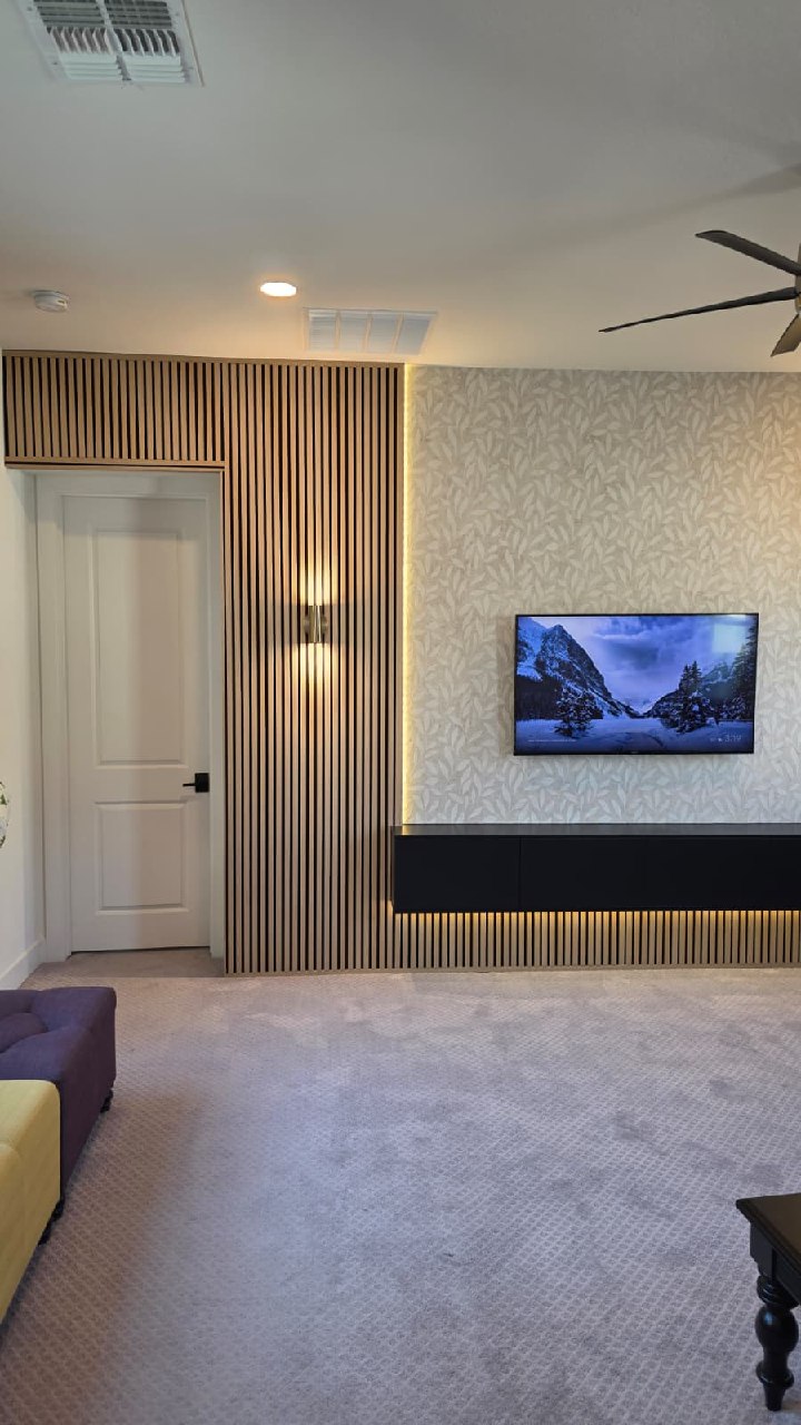 Modern wood slat accent wall with wallpaper center panel and floating media console Arizona